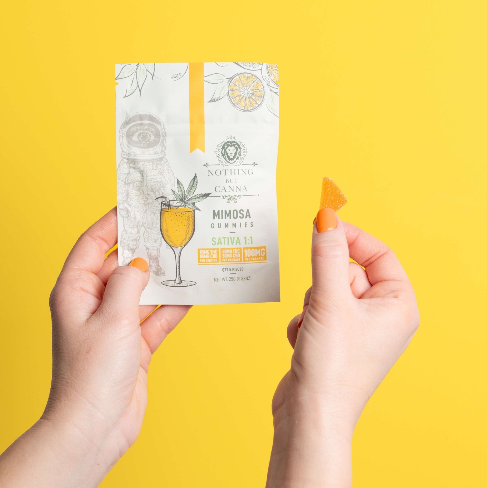 Nothing But Hemp Mimosa hemp-derived THC and CBD sativa gummies package held in one hand while the other hand displays a split half serving gummy against a yellow background in a clean lifestyle product scene